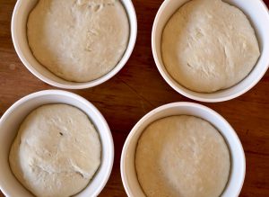 4 bowls with sourdough pizza crust dough